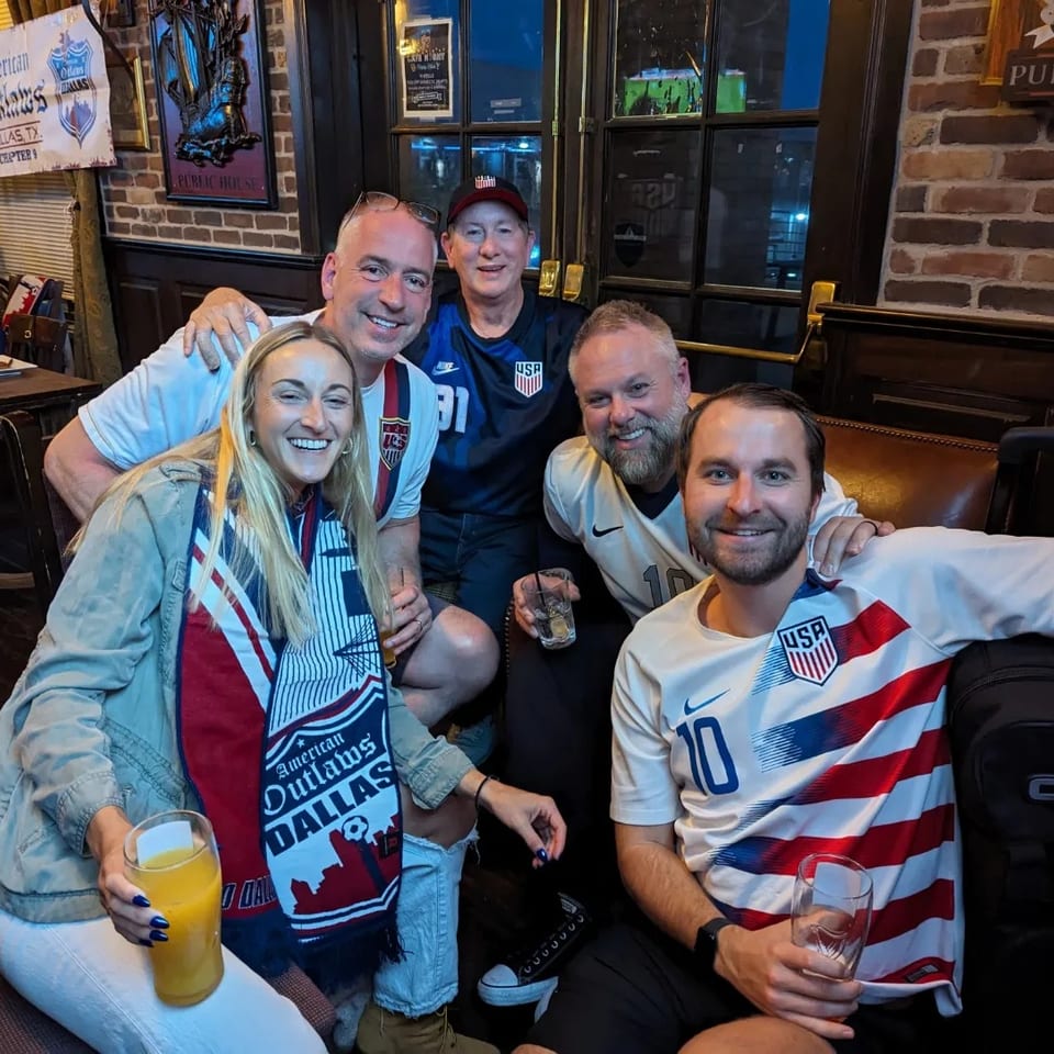 American Outlaws Dallas supporters wearing USA shirts and scarves gathered together at the pub.
